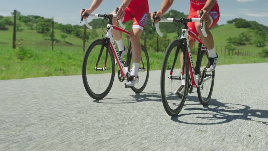 Men in red biking on an empty road