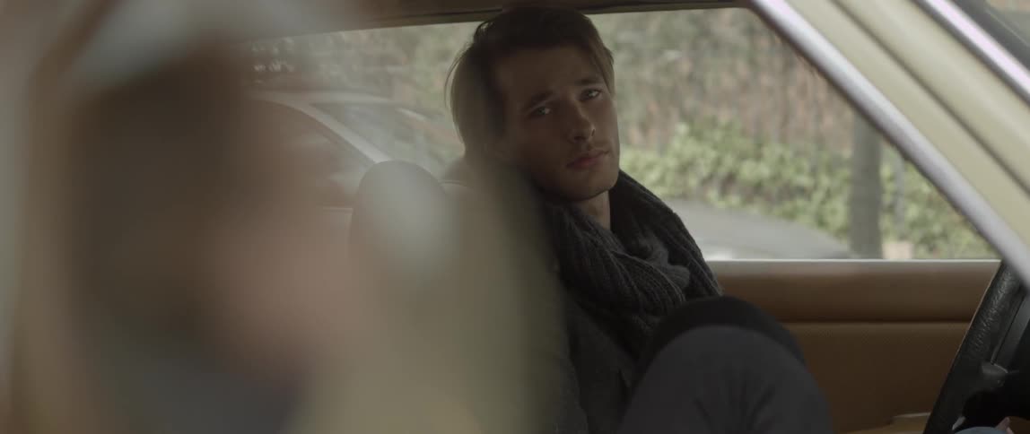 A young man and woman sitting in a car