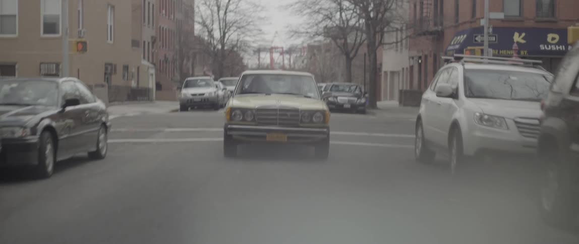 Cars drivin g down a street