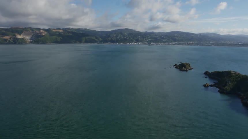 Aerial view of a large lake and surrounding mountains