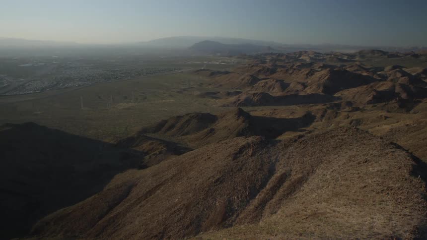 Aerial view of the top of many hills and mountains on a foggy day