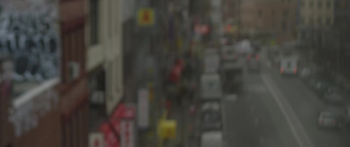 A view of a city's streets and buildings from an elevated train