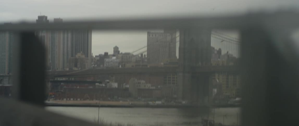View of a highway and city through a guardrail