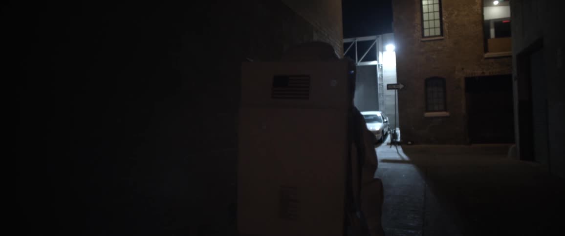 A person wearing space suit walks through a narrow alley