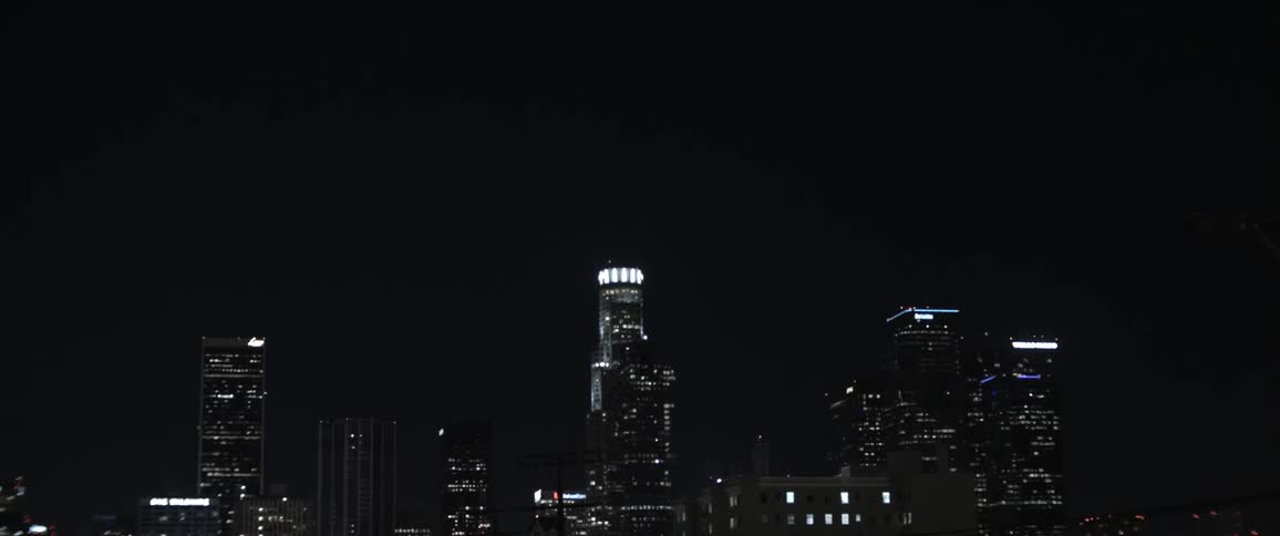 Skyscrapers loom against the night sky