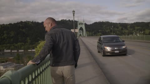 A man walks down the side of the road