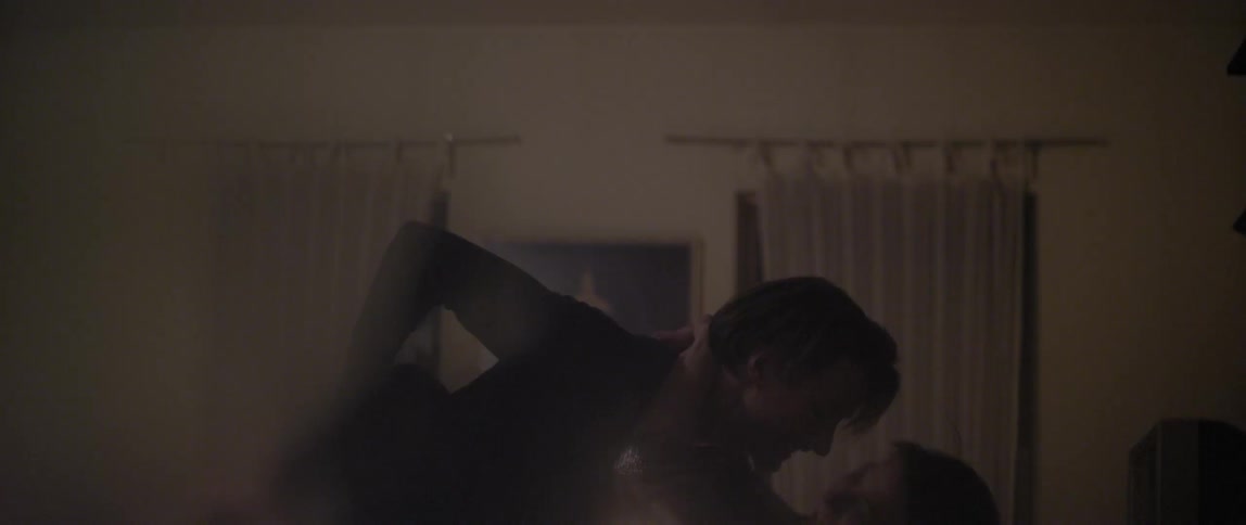 A man holds and swings a woman around