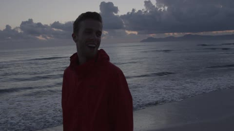 A man walking along the beach