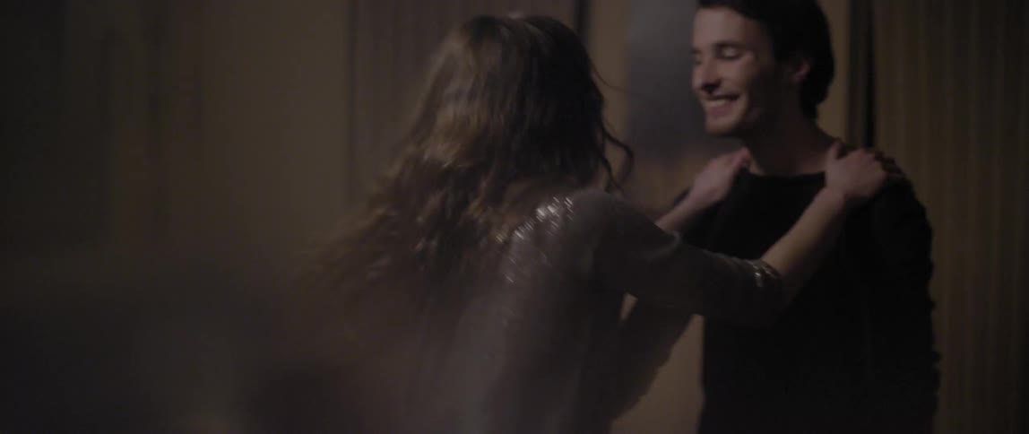 A man and woman dance and laugh