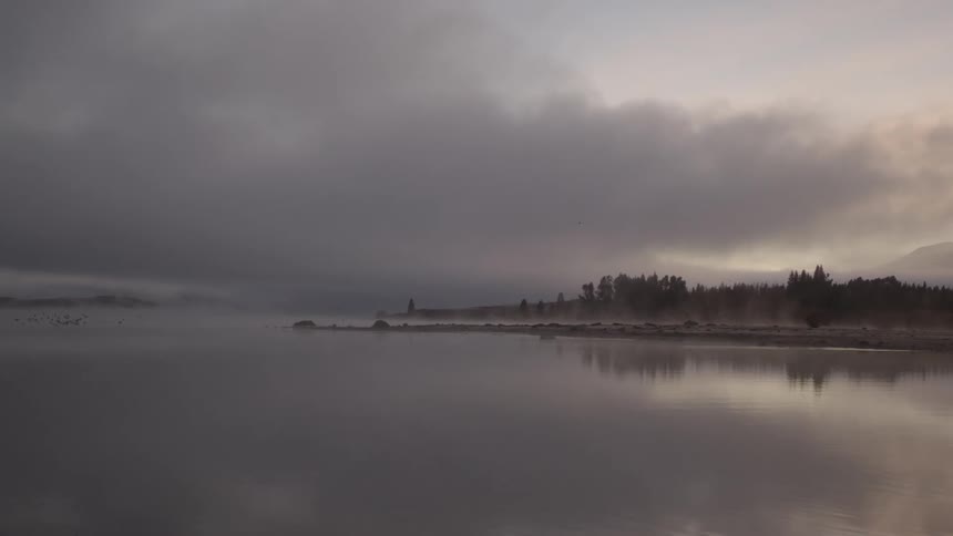 The sea and clouds dominating the scenery while an island sits