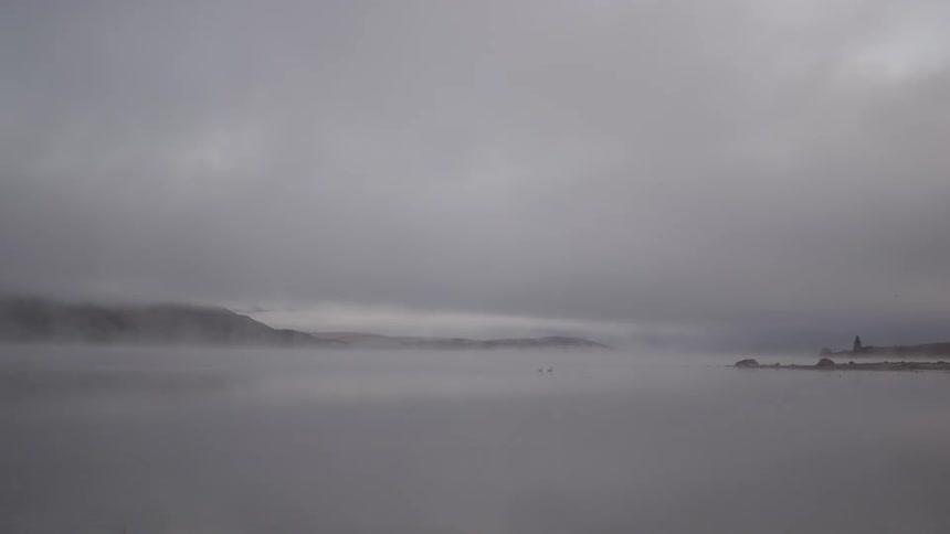 Overcast day with mist rising from a body of water