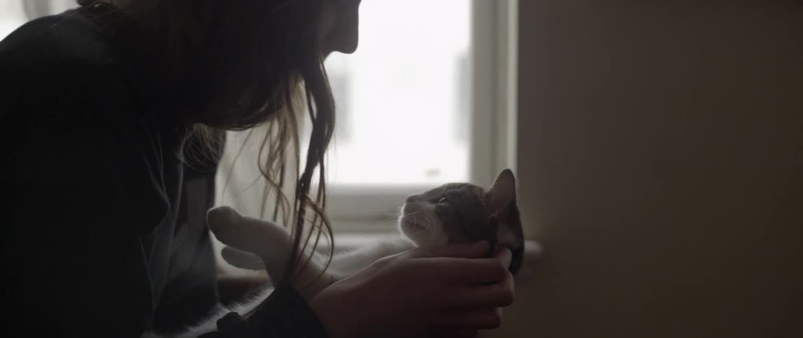 A woman kisses a cat
