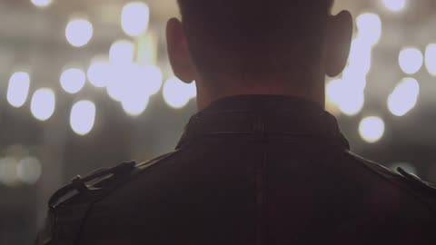 Two people in leather jackets walk