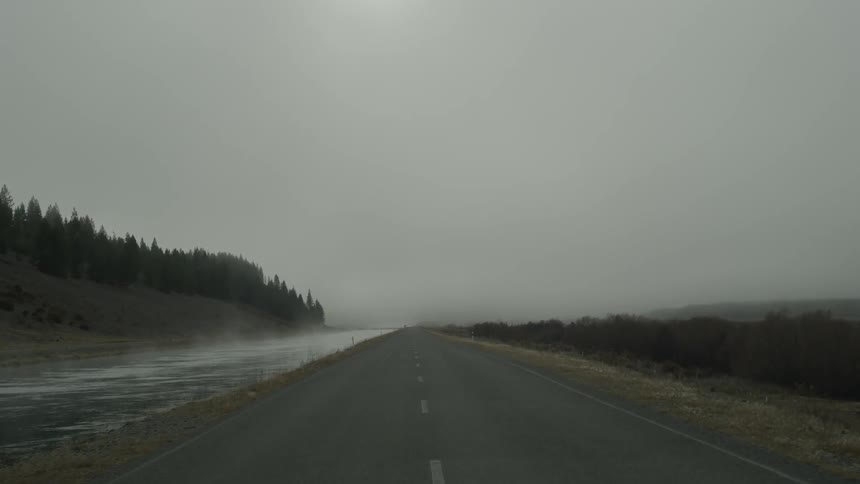 A road near a waterway at dawn