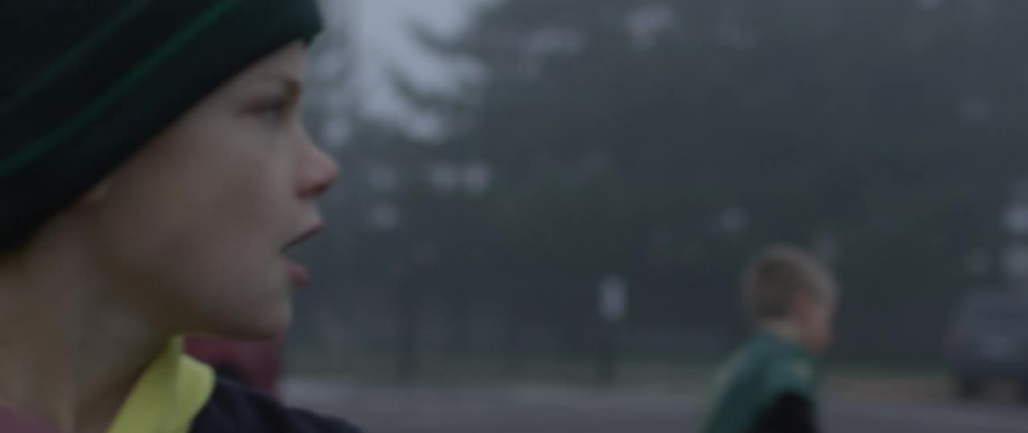 A boy tosses a football to a group of friends