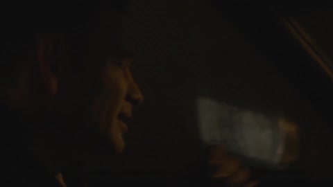 Side view of a man driving at night