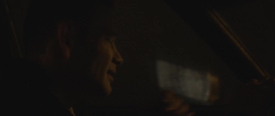 Side view of a man driving at night