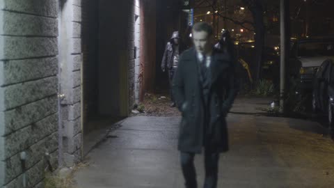 Men strolling a city street at night