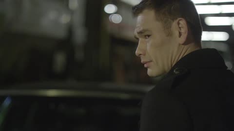 A man in a suit turns around