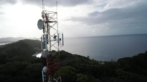 An aerial view of a communication tower near ocean