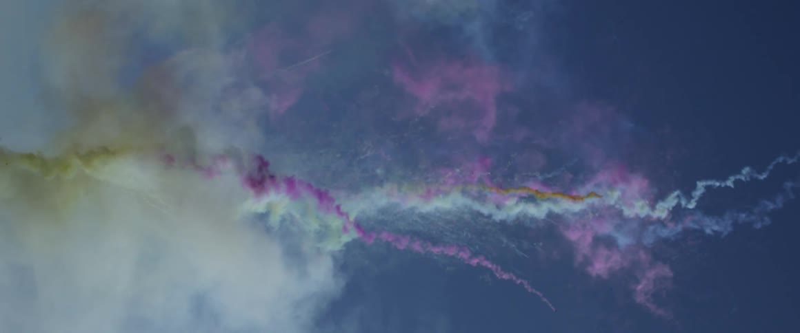 A sky with colored smoke substances covering it