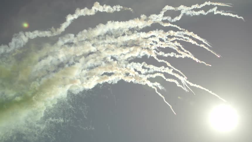 Many green flares flying up in the sky