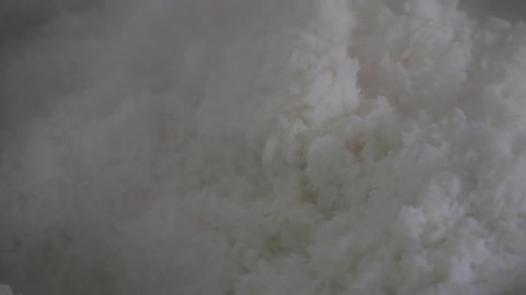 Rice being stirred in a pot