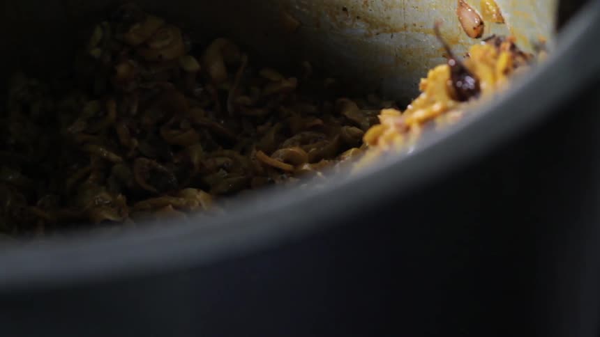 Ingredients are being stirred in a metal pot