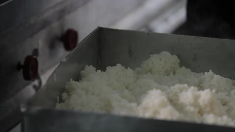 Steam rises from cooked rice