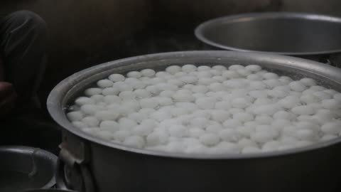 A large portion of eggs being boiled