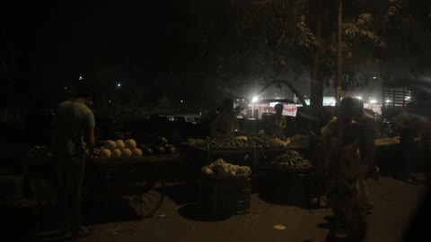 A small fruit stand at night