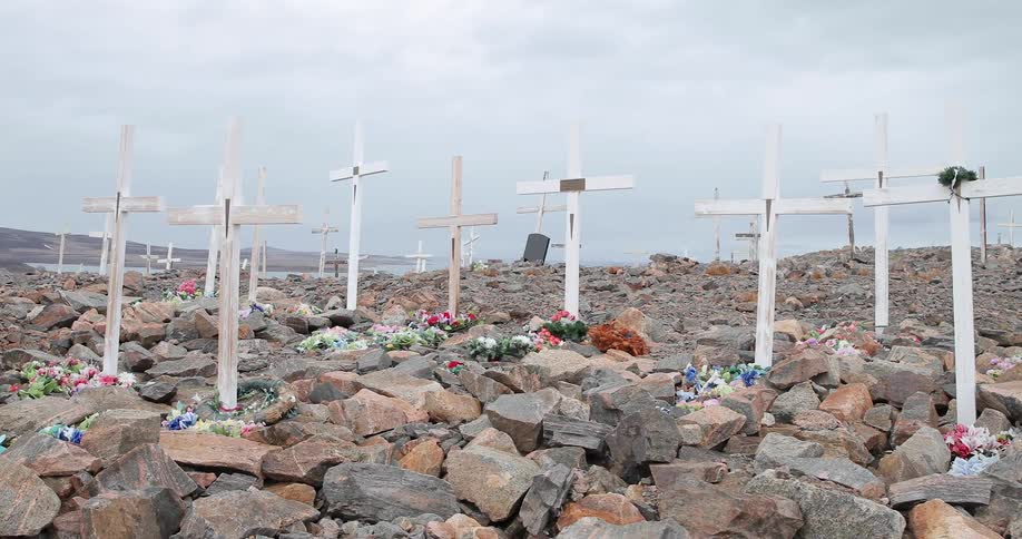 Wooden crosses and flowers mark a mass grave