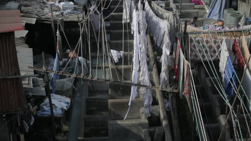 People are washing laundry in sections below clotheslines