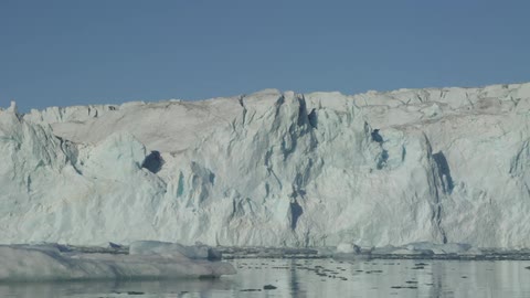A glacier that lies on the arctic water in the day