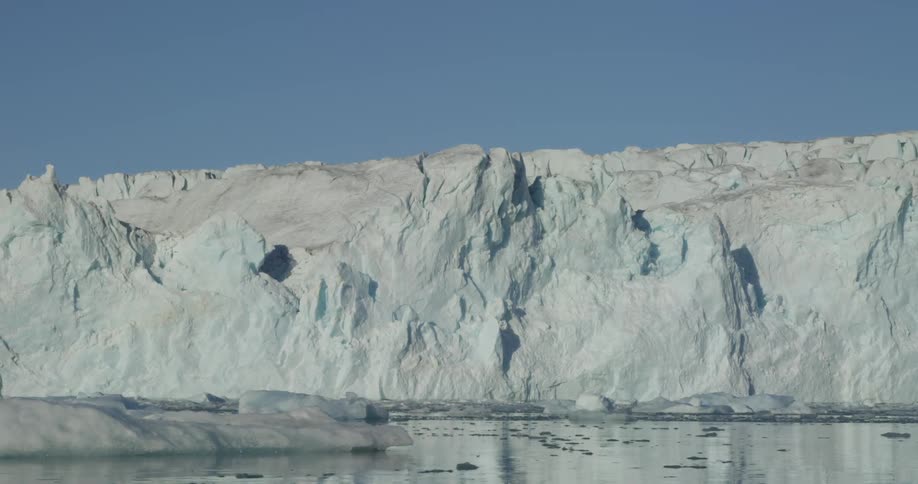 A glacier that lies on the arctic water in the day