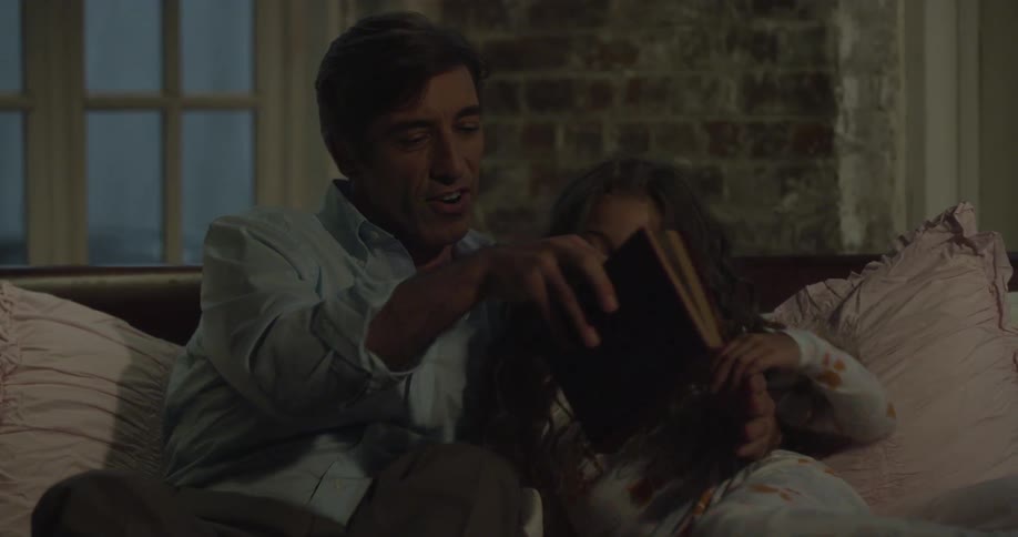 A person sitting to read with a child