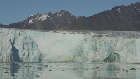 A glacier melts into the ocean