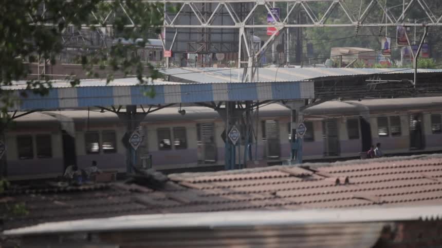 A train passes between two buildings