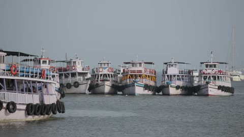 Tugboats float on the ocean