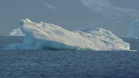 A huge iceberg floats in the water