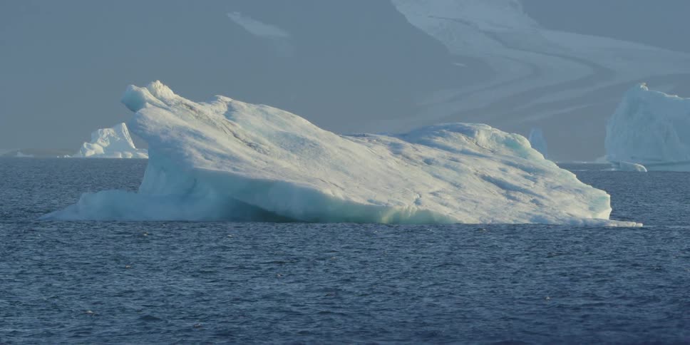 A huge iceberg floats in the water