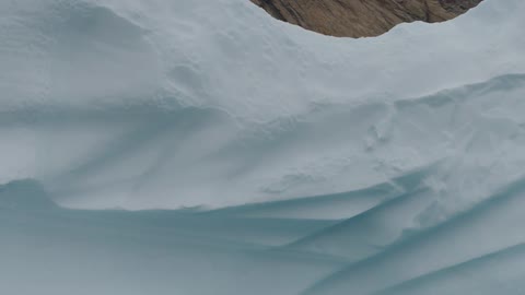 A glacier seen during the day, sailing on the water