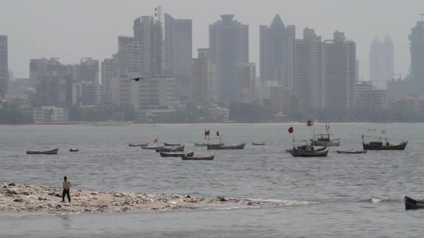 Boats dot the coast of a town