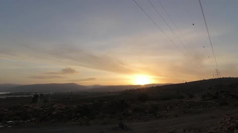 The person walks before sunset