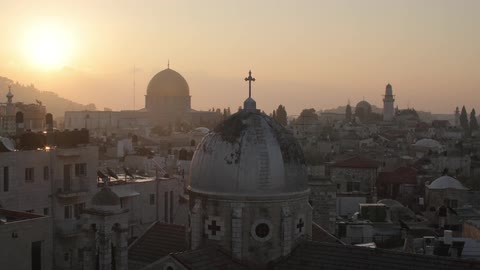 A church with buildings in the background