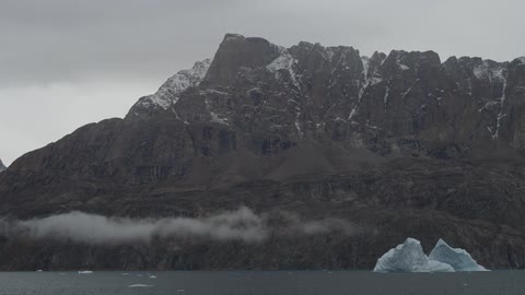 Clouds passing over floating icebergs