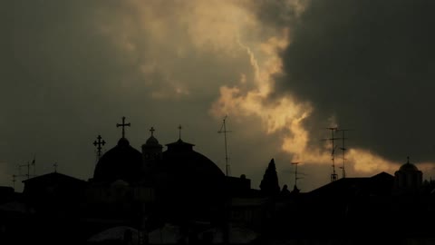 Religious buildings seen during a time lapse that featured clouds covering up the sun