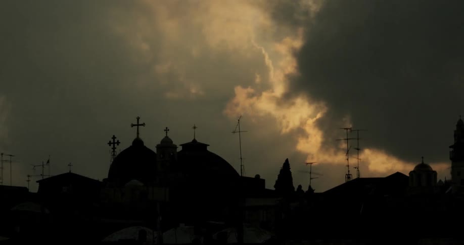 Religious buildings seen during a time lapse that featured clouds covering up the sun