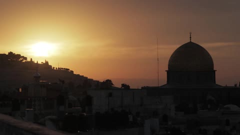 A gold domed building at dusk
