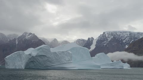A cloudy day with the water moving slowly by ice
